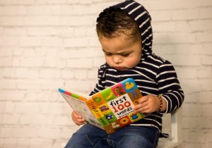 toddler-reading-book-library Toddler reading a book