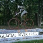 Glacial River Trail sculpture of girl on a bike