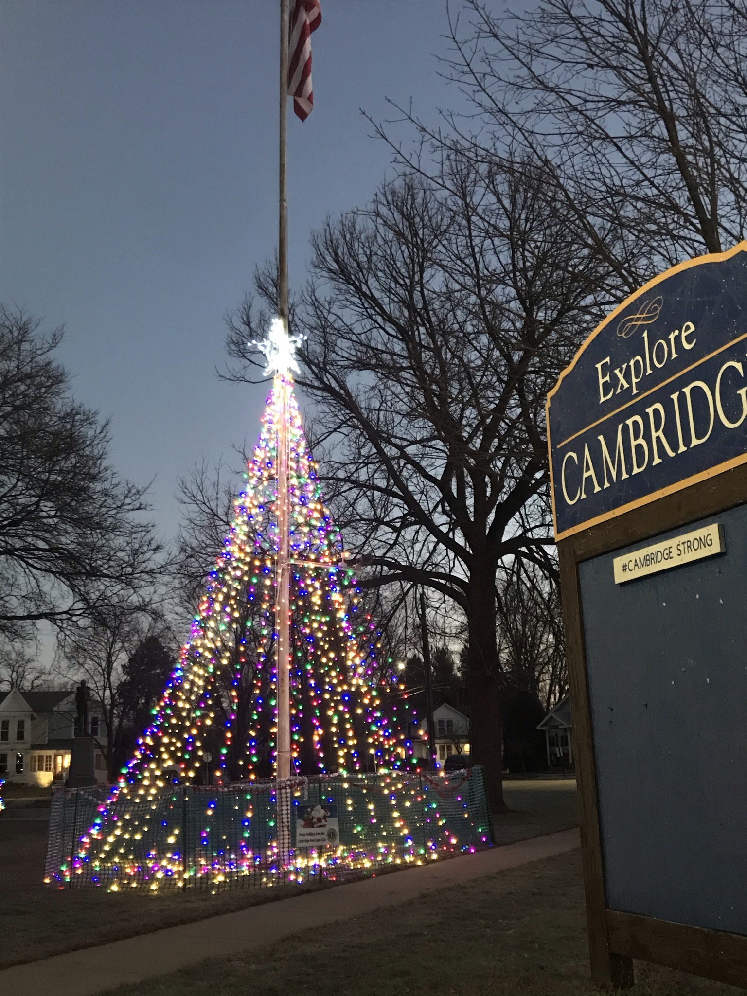 Cambridge's Downtown Veteran's Park flagpole Christmas Tree with Explore Cambridge sign