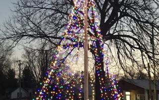 Cambridge's Downtown Veteran's Park flagpole Christmas Tree with multicolored lights and star on top