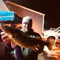 Man holding a large fish caught at the Lions Club Fisheree on Lake Ripley