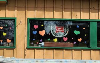 Sports Page Bar & Grill hearts in window showing their love