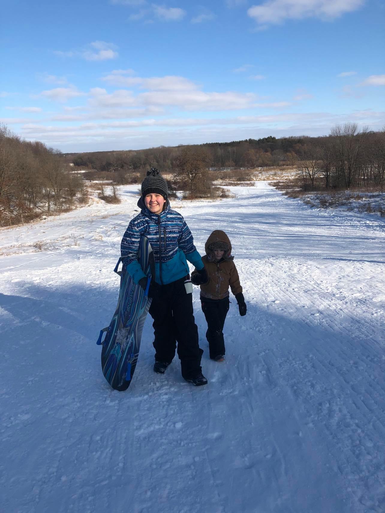 Kids sledding on Camrock County Trail 3, Cambridge 2020