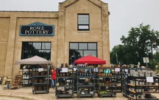 Exterior view of Rowe Pottery Works and sidewalk sale at Maxwell Street Days