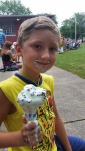 Kid eating ice cream cone at Watertown Riverfest