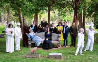 Group of 10 people in a graveyard dressed in spooky costumes