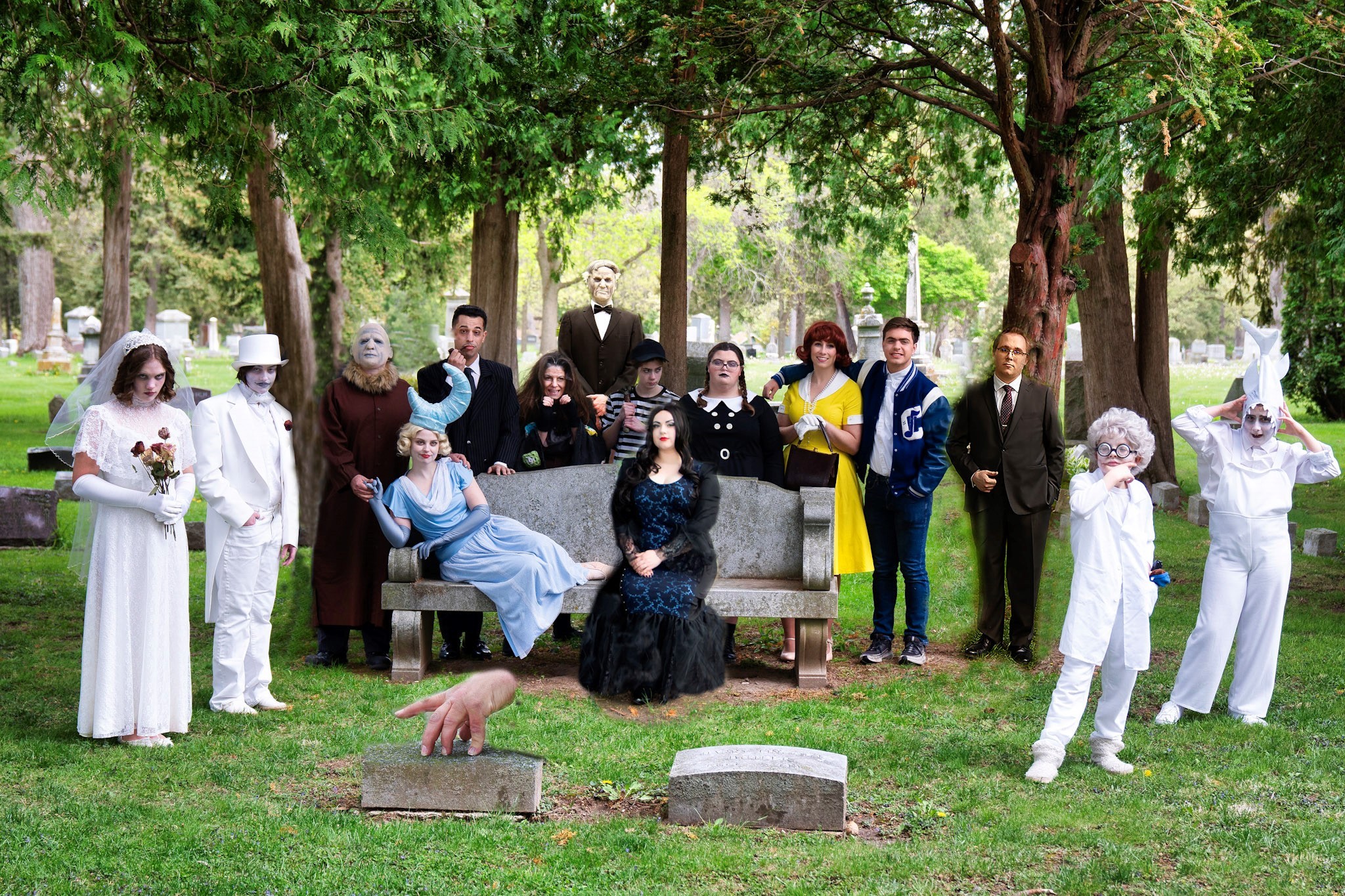 Group of 10 people in a graveyard dressed in spooky costumes