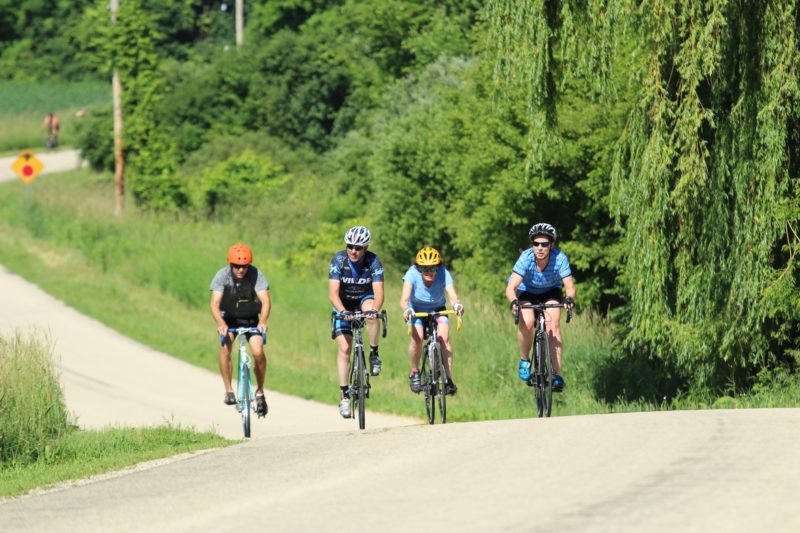 4 cyclists riding up a hill at the Tour da Goose bike ride