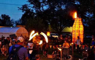 Evening shot of fire dancers and kiln at Midwest Fire Fest