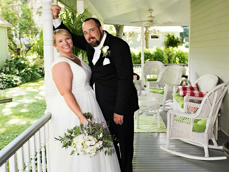 Couple posing on their own porch An Elegant Birchwood Wedding at Windwood of Watertown