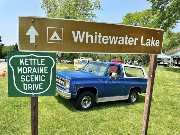 Cars-and-coffee-whitewater-lake-sign-and-blue-bronco copy
