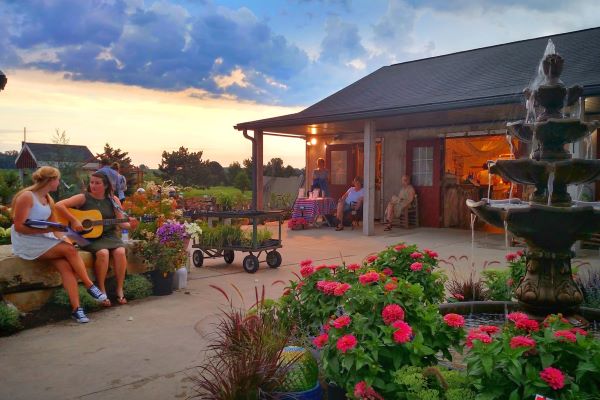 Eberts-Greenhouse-Village-woman-with-guitar