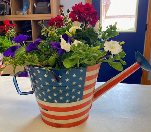 Eberts-red-white-blue-watering-can-with-flower-arrangement